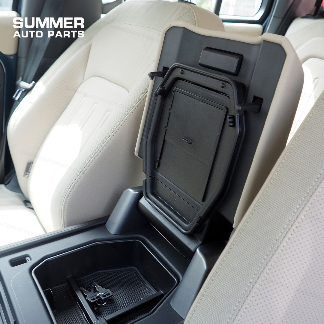 Side view of installed armrest cover privacy storage box in Land Rover Defender L663 cabin