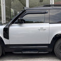 Side view of black Union Jack side steps installed on Land Rover Defender 90 L663