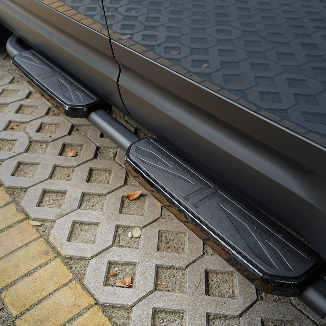 Close-up of black Union Jack side steps installed on Land Rover Defender L663