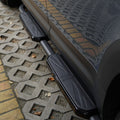 Detail view of black Union Jack side steps installed on Land Rover Defender L663