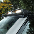 Close-up of forged carbon fiber roof light bar illuminated on Land Rover Defender L663 roof