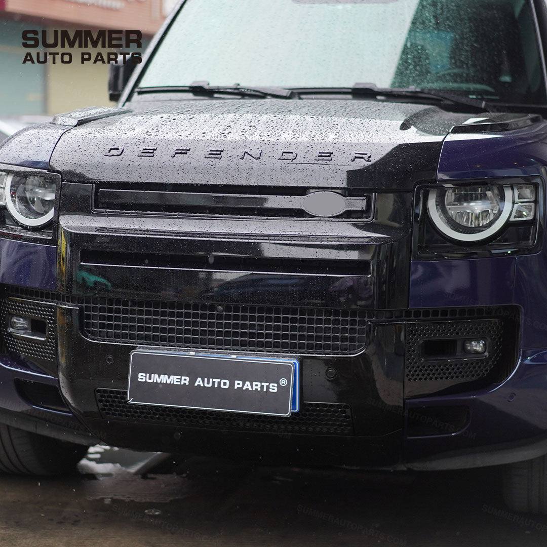 Close-up of installed gloss black front bumper kit on Land Rover Defender L663
