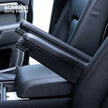 Side view of black front seat armrests installed on Land Rover Defender L663
