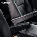 Close-up of black front seat armrests installed between Defender L663 seats
