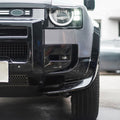 Close-up of black Union Jack side steps installed on Land Rover Defender L663