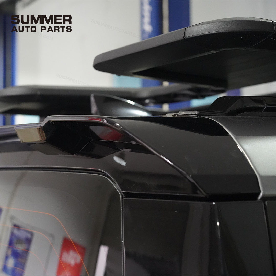 Close-up of installed gloss black rear roof spoiler on Land Rover Defender L663