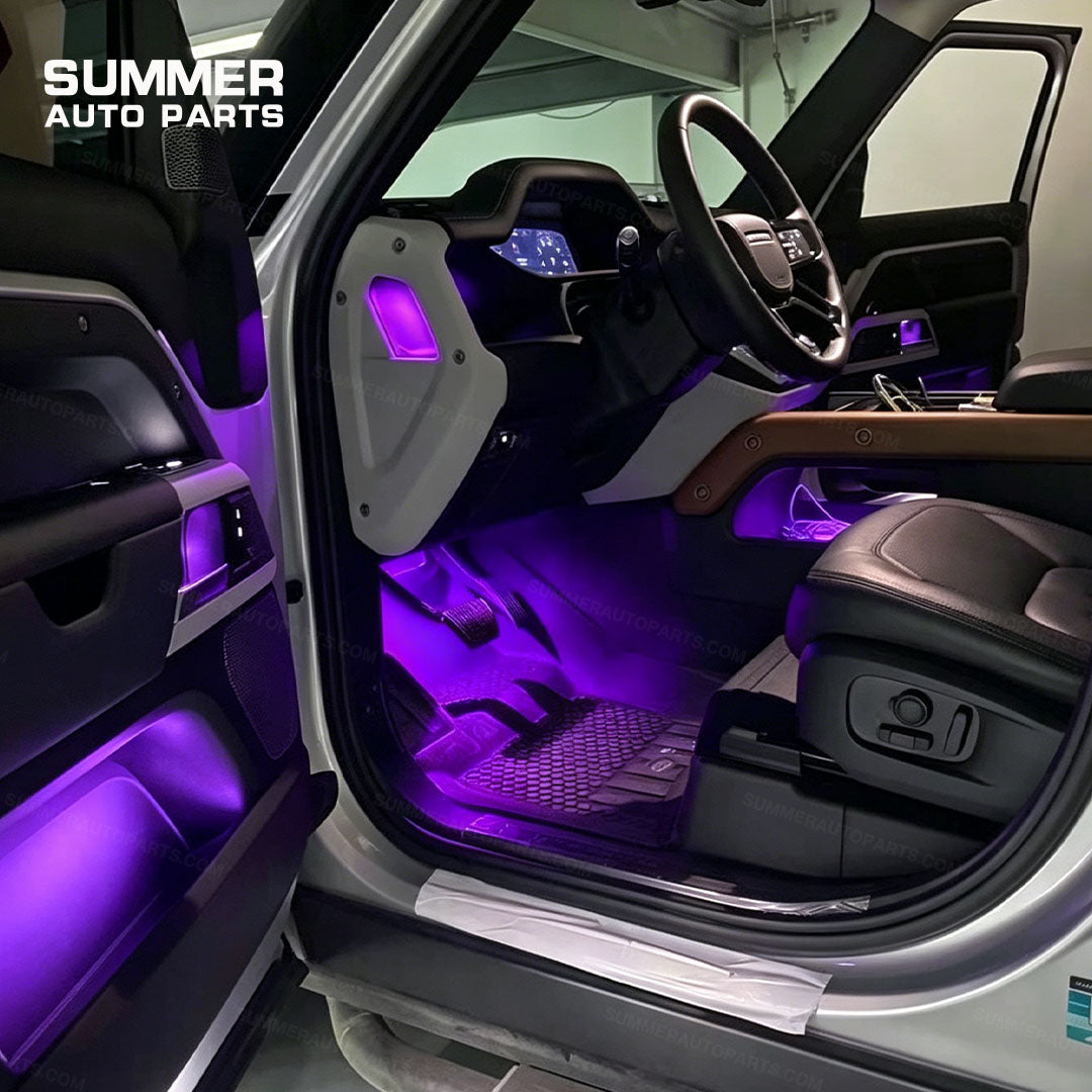 Purple interior ambient lighting installed in the door, dashboard, and footwell areas of Land Rover Defender L663
