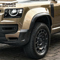 Front wheel view of OCTA style satin carbon wheel arches installed on Land Rover Defender L663